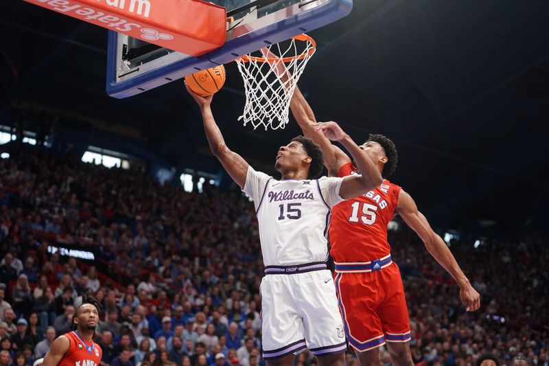 Kansas State Wildcats forward Taj Manning (15) shoots the ball against Kansas Jayhawks during the Sunflower Showdown game inside Allen Fieldhouse in Lawrence, Kansas, on Saturday, March 7, 2026.