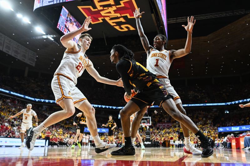 Mar 7, 2026; Ames, Iowa, USA; Arizona State Sun Devils guard Trevor Best (12) is defended by Iowa State Cyclones guard Jamarion Batemon (1) and forward Dominykas Pleta (21) during the second half at James H. Hilton Coliseum. Mandatory Credit: Jeffrey Becker-Imagn Images