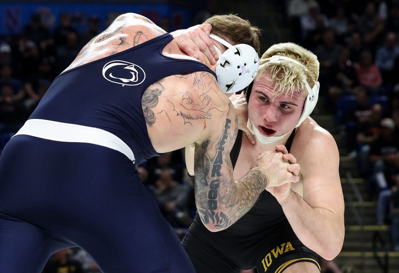 Mar 7, 2026; University Park, PA, USA; Iowa’s Angelo Ferrari (right) wrestles Penn State’s Rocco Welsh (left) in a 184-pound bout during the quarterfinals of the Big Ten Wrestling Championships at Bryce Jordan Center. Mandatory Credit: Matthew O'Haren-Imagn Images