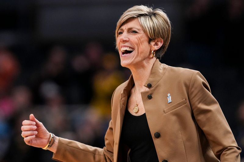 Iowa Hawkeyes head coach Jan Jensen celebrates Saturday, March 7, 2026, during a Big Ten women's basketball tournament semifinals game at Gainbridge Fieldhouse in Indianapolis. The Iowa Hawkeyes defeated the Michigan Wolverines, 59-42.