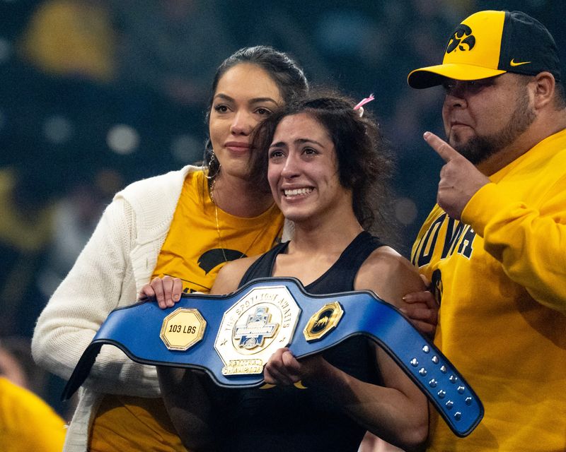 Iowa’s Valarie Solorio stands with supporters after winning her 103-pound finals match March 7, 2026 during the NCAA Women’s Wrestling Championship at Xtream Arena in Coralville, Iowa.