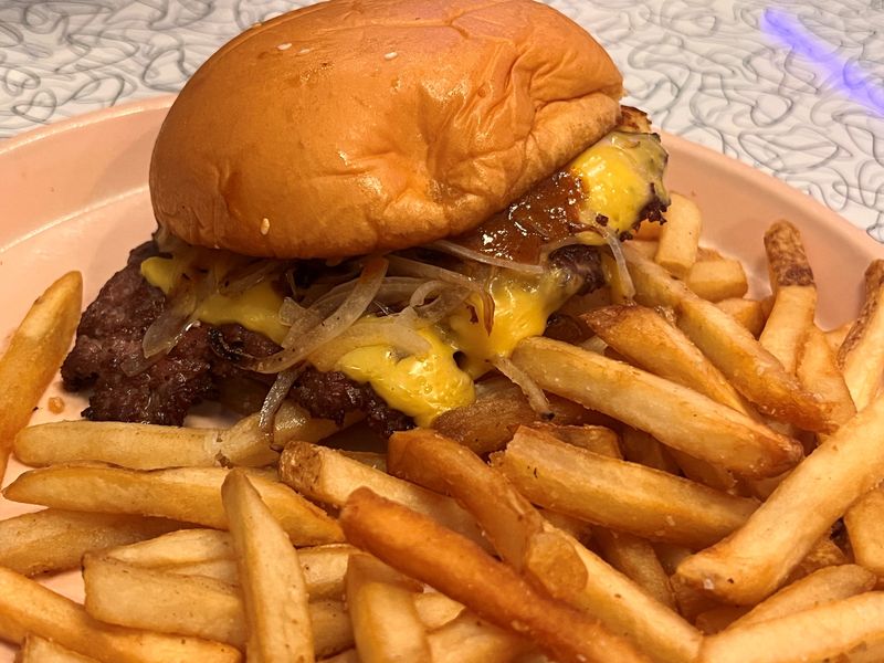 The Boom Boom Burger at Lachele's Fine Foods in Highland Park in Des Moines comes with a smash patty, American cheese, grilled onion, Boom Boom sauce and mayo on a potato roll.