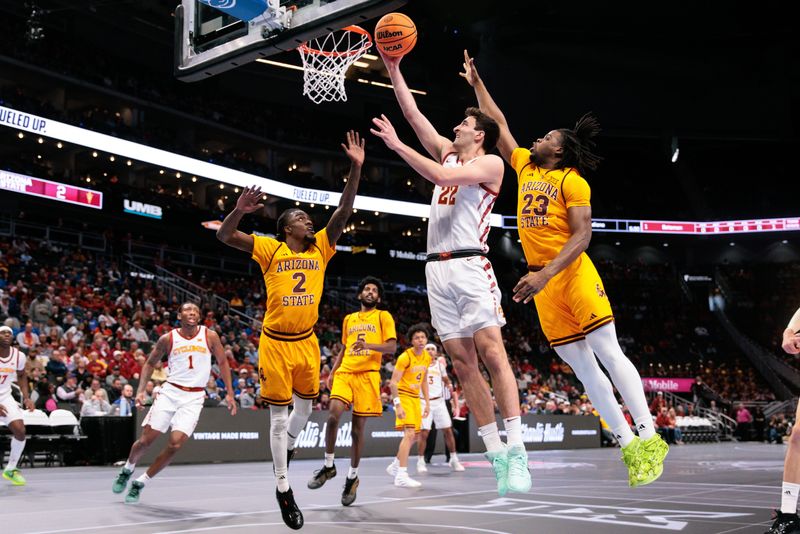 Mar 11, 2026; Kansas City, MO, USA; Iowa State Cyclones forward Milan Momcilovic (22) shoots the ball around Arizona State Sun Devils forward Allen Mukeba (23) during the first half at T-Mobile Center. Mandatory Credit: William Purnell-Imagn Images