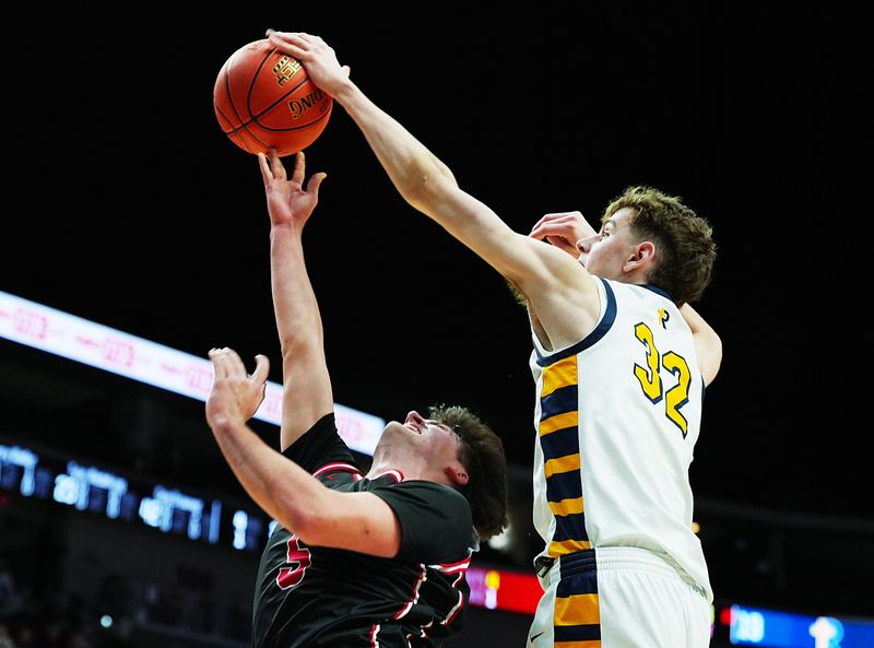 Regina Catholic forward Ben Wade (32) blocks the ball as Aplington-Parkersburg guard Benny Waller (5) shoots during a Class 2A IHSAA state quarterfinal on March 11, at Casey’s Center in Des Moines.