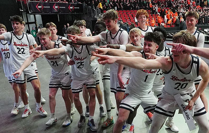 The Ballard boys basketball team celebrates by pointing to the Class 3A bracket after holding off Carroll, 57-55, in the state semifinals on March 11 at the Casey’s Center in Des Moines.