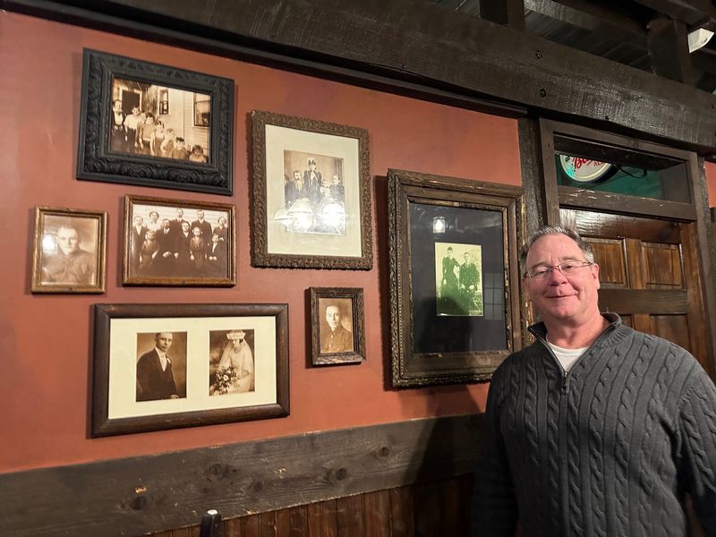 Donny O'Brien, owner of Dublin Bay Irish Pub & Grill, poses in the dining room of the pub where the walls feature photos of his Irish ancestors.
