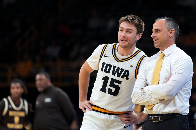 Iowa guard Brendan Hausen (15) talks to Iowa head coach Ben McCollum during a basketball game against the Western Michigan Broncos Dec. 14, 2025 at Carver-Hawkeye Arena in Iowa City, Iowa.
