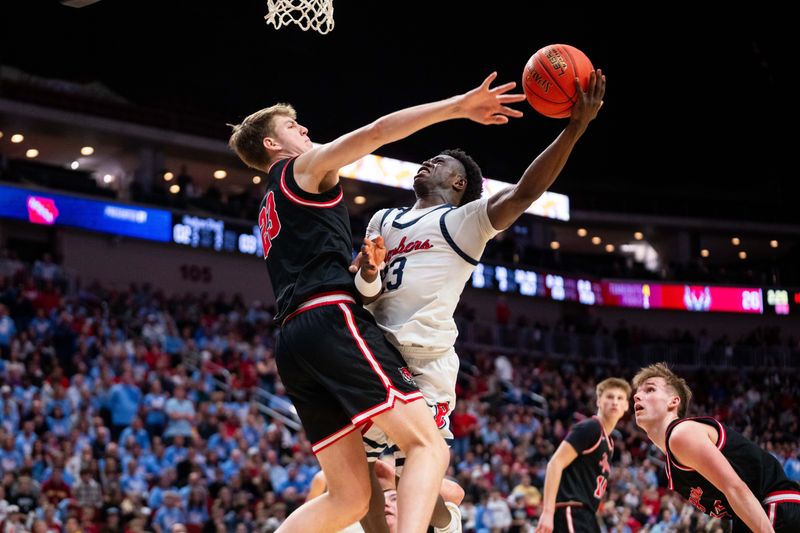 Ballard’s Jude Gibson (23) shoots against ADM's Reece Strittmatter (23) on March 13, 2026, at Casey's Center in Des Moines.