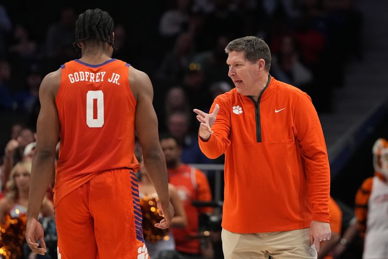 Mar 13, 2026; Charlotte, NC, USA; Clemson Tigers forward RJ Godfrey (0) with head coach Brad Brownell in the second half at Spectrum Center. Mandatory Credit: Bob Donnan-Imagn Images