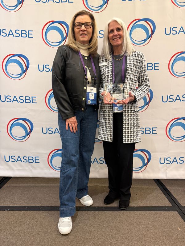 Linda Niehm (left), with ISU's College of Health and Human Sciences, and Judi Eyles, Pappajohn Center director, accept the Excellence in Co-Curricular Innovation Award.