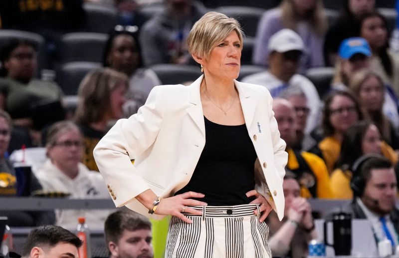 Iowa Hawkeyes head coach Jan Jensen watches the game from the sidelines Sunday, March 8, 2026, during the Big Ten Tournament Championship game at Gainbridge Fieldhouse in Indianapolis. UCLA Bruins defeated the Iowa Hawkeyes, 96-45, for back to back Big Ten championships.