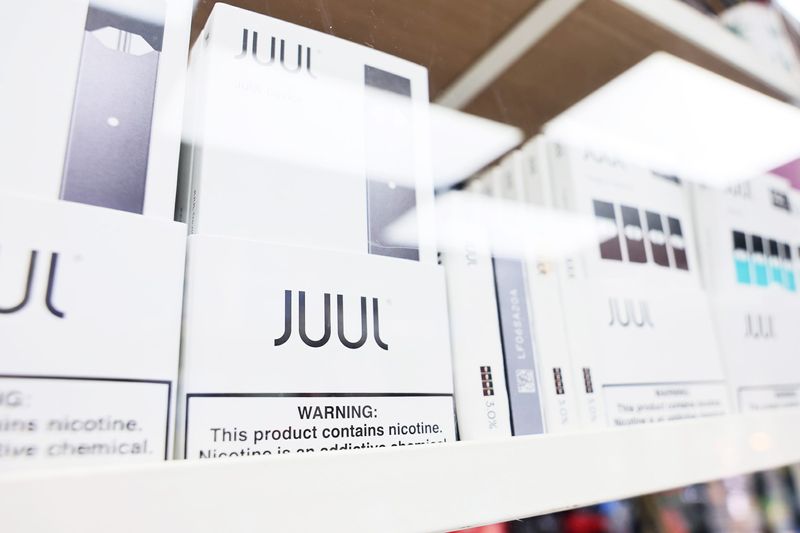 Juul packages are seen on a shelf.