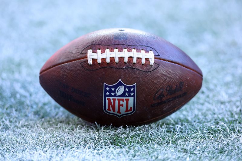 Dec 7, 2025; Glendale, Arizona, USA; Detailed view of the NFL shield logo on an official Wilson football during the Arizona Cardinals game against the Los Angeles Rams at State Farm Stadium. Mandatory Credit: Mark J. Rebilas-Imagn Images