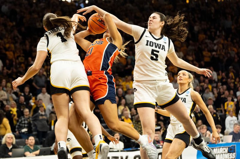 Iowa guard Taylor Stremlow (1) and Iowa center Ava Heiden (5) defend Virginia guard Kymora Johnson (21) as she drives to the basket March 23, 2026 during a Round of 32 NCAA March Madness game at Carver-Hawkeye Arena in Iowa City, Iowa.