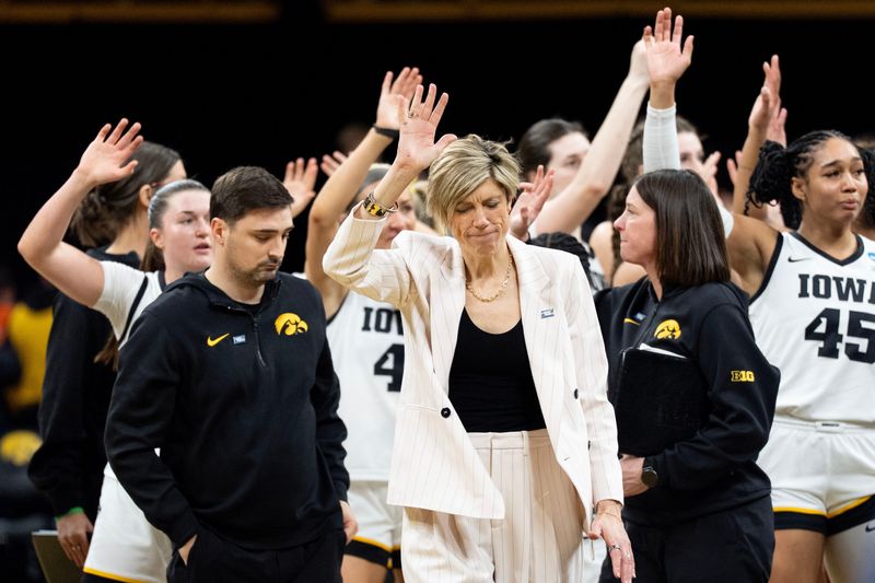 The Iowa Hawkeyes womenâ€™s basketball team and staff wave to fans as they walk off the court following a double overtime loss to against the Virginia Cavaliers March 23, 2026 during a Round of 32 NCAA March Madness game at Carver-Hawkeye Arena in Iowa City, Iowa.