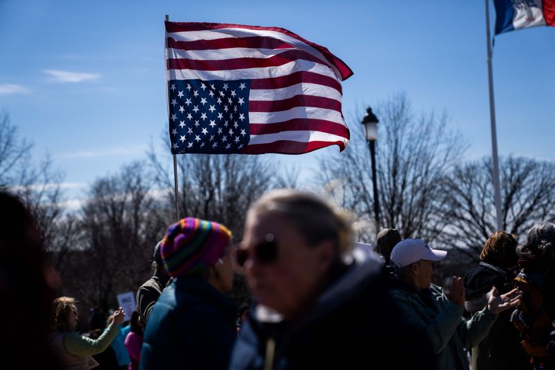 Protesters gather outside the Iowa State Capitol for the third edition of the No Kings protest on March 28, 2026, in Des Moines.