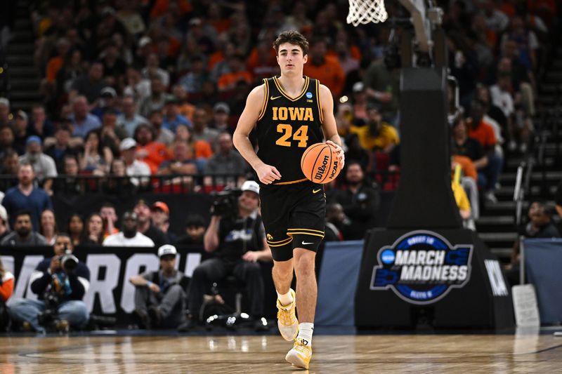 Mar 28, 2026; Houston, TX, USA; Iowa Hawkeyes guard Tate Sage (24) controls the ball against the Illinois Fighting Illini in the first half during an Elite Eight game of the South Regional of the men's 2026 NCAA Tournament at Toyota Center. Mandatory Credit: Maria Lysaker-Imagn Images