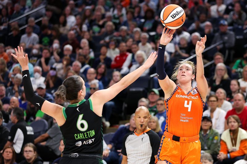 Oct 1, 2024; Minneapolis, Minnesota, USA; Connecticut Sun guard Marina Mabrey (4) shoots as Minnesota Lynx forward Bridget Carleton (6) defends during the second half of game two of the 2024 WNBA Semi-finals at Target Center. Mandatory Credit: Matt Krohn-Imagn Images