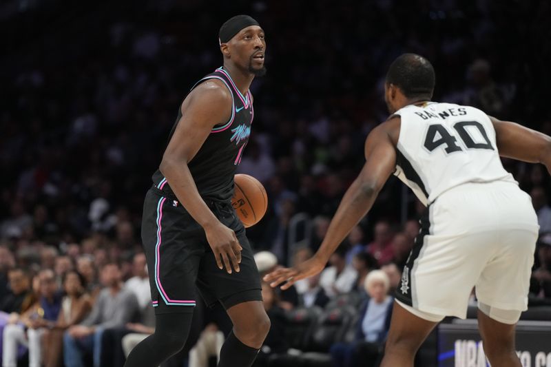 Miami, Florida, USA; Miami Heat center Bam Adebayo (13) looks to pass the ball as San Antonio Spurs forward Harrison Barnes (40) defends during the first half at Kaseya Center.