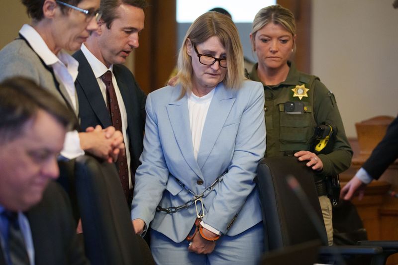 Kristin Ramsey enters a hearing at the Dallas County Courthouse, April 10, 2026. Ramsey, 53, was charged in March with first-degree murder for the 2011 shooting of Ashley Okland.