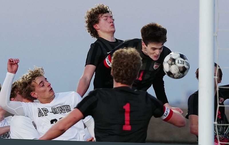 Gilbert's Logan Harswick (11) gets by Aplington-Parkersburg's Bentley Frisch (21) as he heads the ball toward the goal during the first half of the Tigers' 4-0 victory over the Falcons at Tiger Stadium on April. 10 in Gilbert, Iowa.