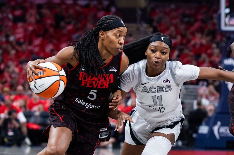 Sep 28, 2025; Indianapolis, Indiana, USA; Indiana Fever guard Shey Peddy (5) dribbles the ball while Las Vegas Aces guard Dana Evans (11) defends in the first half during game four of the second round for the 2025 WNBA Playoffs at Gainbridge Fieldhouse. Mandatory Credit: Trevor Ruszkowski-Imagn Images