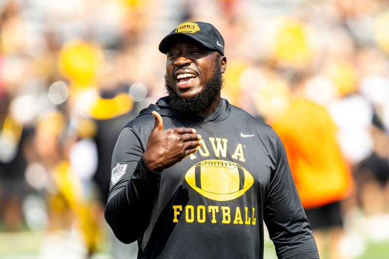 Aug 9, 2025; Iowa tight ends and fullbacks coach Abdul Hodge talks with players during the Hawkeyes Kids Day NCAA football open practice at Kinnick Stadium in Iowa City, Iowa. Mandatory Credit: Joseph Cress for the Des Moines Register