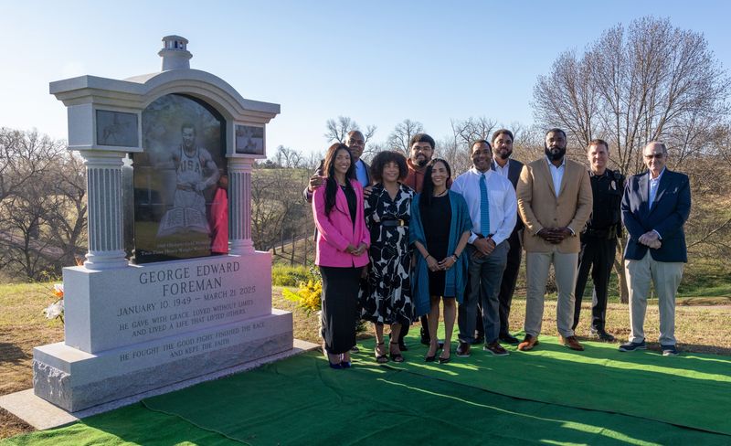 Sioux City Mayor Bob Scott, far right, and Sioux City Police Chief Rex Mueller, second from right, stand with George Foreman's family members as they honor his legacy.
