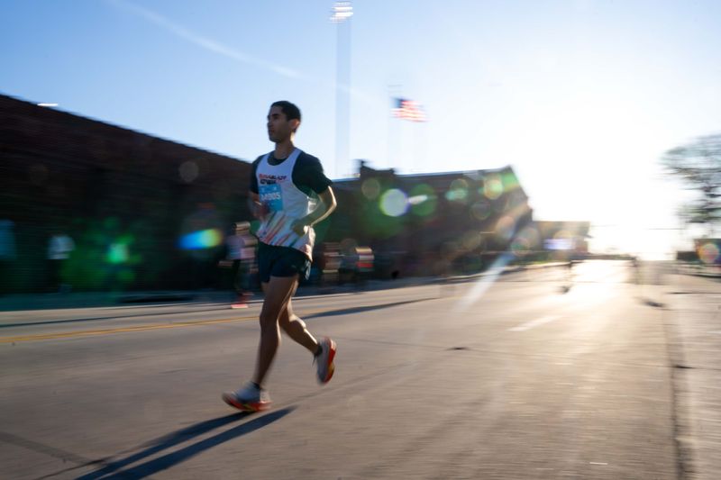 Runners warm up for the Drake Relays Road Races on April 18, 2026, in Des Moines.