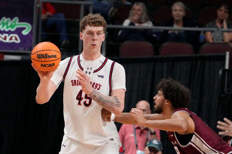 March 9, 2026; Las Vegas, NV, USA; Saint Mary's Gaels center Andrew McKeever (45) passes the basketball against Santa Clara Broncos center Bukky Oboye (12) during the first half at Orleans Arena. Mandatory Credit: Kyle Terada-Imagn Images