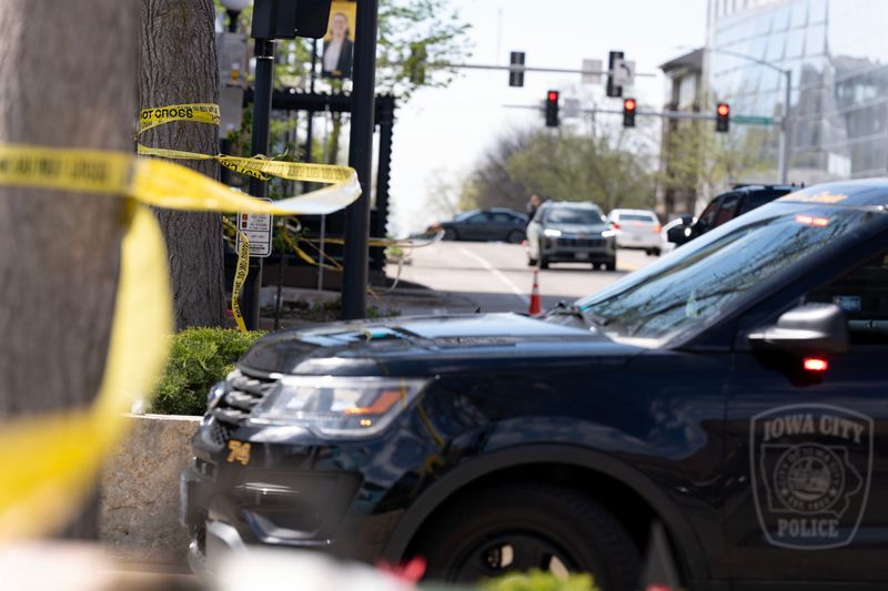 Crime scene tape ropes off the Clinton Street entrance to the pedestrian mall as law enforcement investigate a shooting April 19, 2026 in downtown Iowa City, Iowa.
