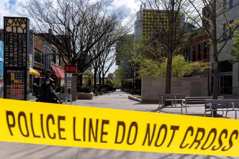 Crime scene tape ropes off the Clinton Street entrance to the pedestrian mall as law enforcement investigate a shooting April 19, 2026 in downtown Iowa City, Iowa.