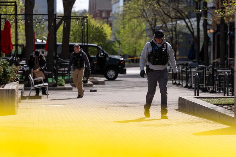 Iowa City law enforcement personnel investigate at the scene of a shooting April 19, 2026 on the pedestrian mall in downtown Iowa City, Iowa.