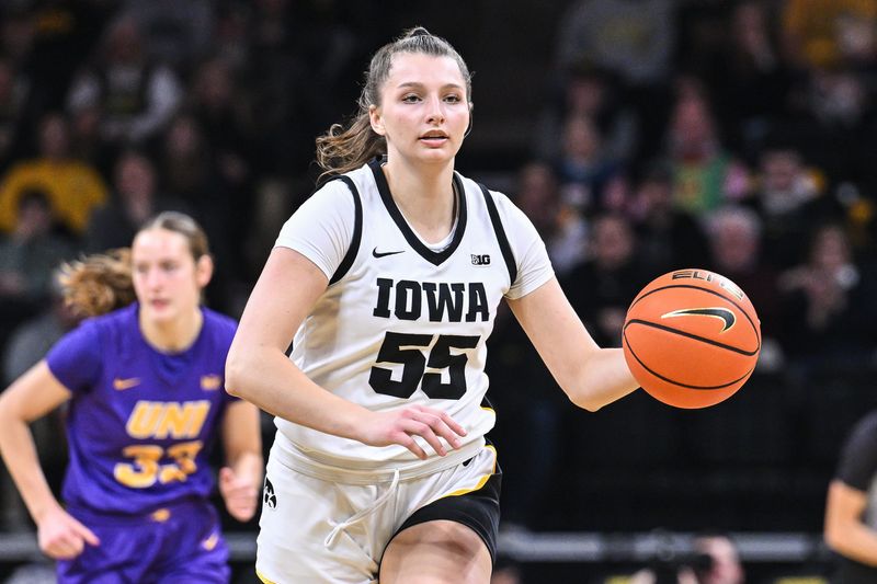 Dec 20, 2024; Iowa City, Iowa, USA; Iowa Hawkeyes guard Teagan Mallegni (55) controls the ball against the Northern Iowa Panthers during the first quarter at Carver-Hawkeye Arena. Mandatory Credit: Jeffrey Becker-Imagn Images