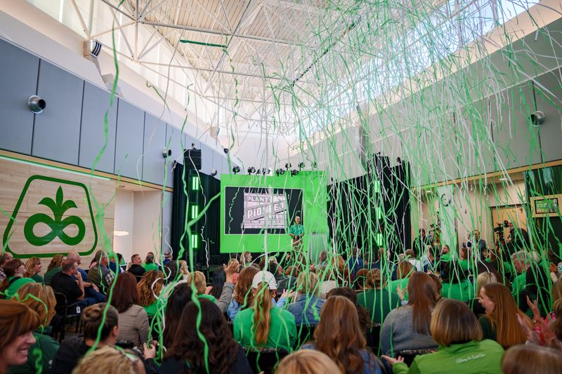 Green and white streamers rain down on the audience as current and former Corteva Agriscience employees gather to celebrate Pioneer's 100th anniversary, Monday, April 20, 2026, in Johnston.