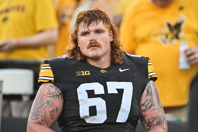 Sep 13, 2025; Iowa City, Iowa, USA; Iowa Hawkeyes offensive lineman Gennings Dunker (67) looks on before the game against the Massachusetts Minutemen at Kinnick Stadium. Mandatory Credit: Jeffrey Becker-Imagn Images