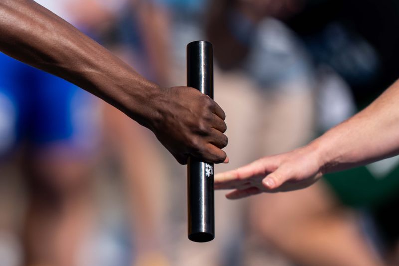 Runners hand off the baton during the boys 4x100 on April 25, 2026, at Drake Stadium in Des Moines.