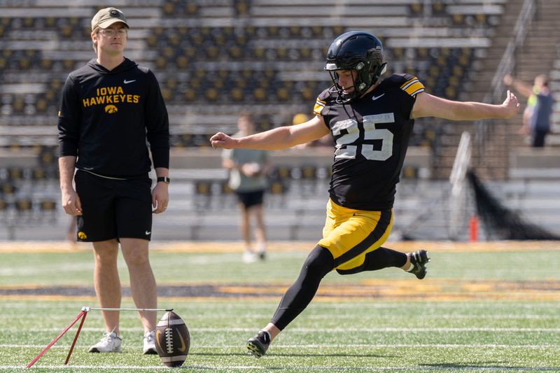 Iowa placekicker Eli Ozick (25) warms up April 25, 2026 during the team’s spring practice at Kinnick Stadium in Iowa City, Iowa.