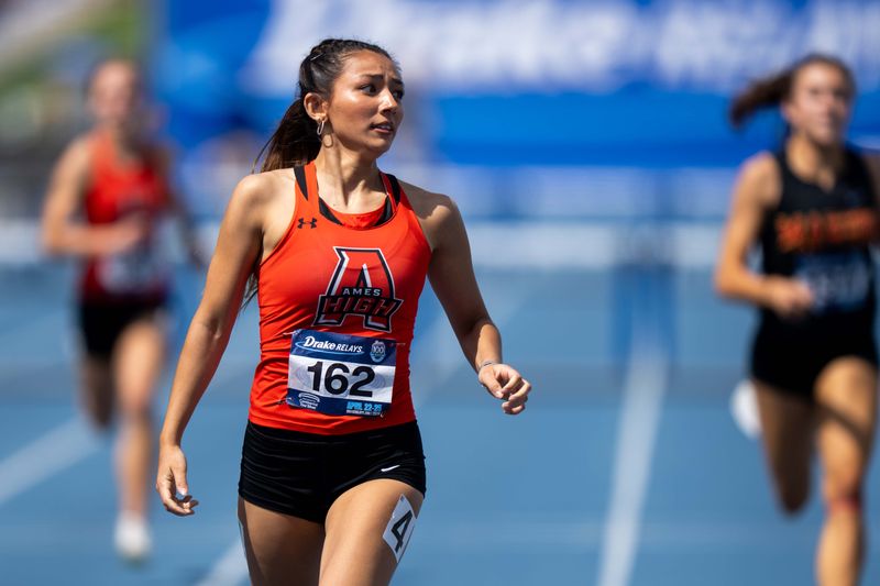 Ames’ Angelica Attinger crosses the finish line in the girls 400m hurdles on April 25, 2026, at Drake Stadium in Des Moines.