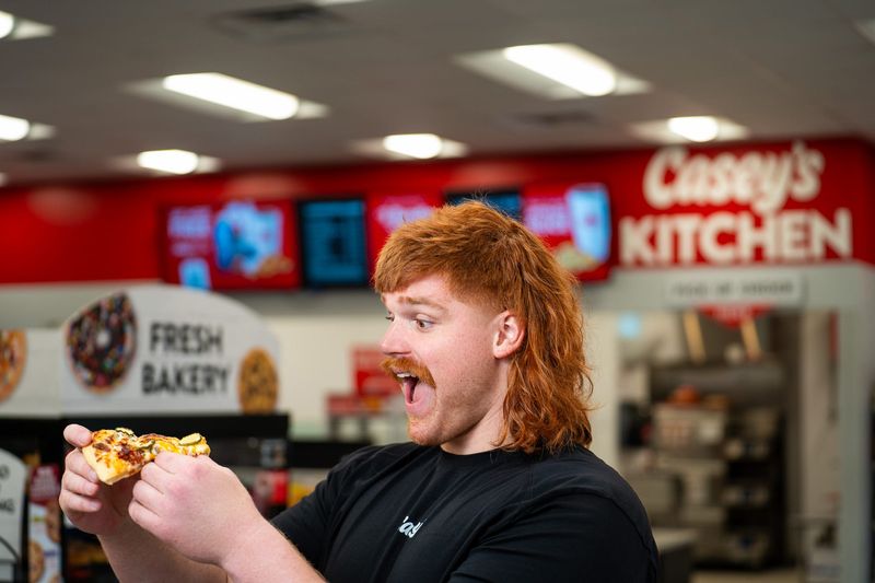 Former Iowa football star Gennings Dunker has partnered with Casey's General Stores to announce the return of its Bacon Cheeseburger pizza.