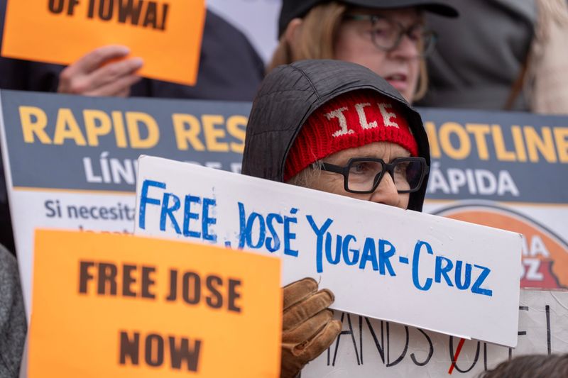 People hold signs in support of Bolivian national JosŽ Yugar-Cruz who faces deportation to the Democratic Republic of Congo during a rally April 30, 2026 outside the Linn County Courthouse in Cedar Rapids, Iowa.