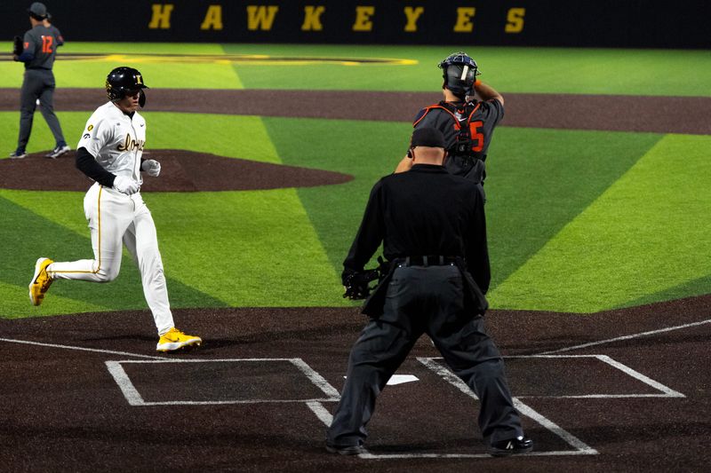 Iowa’s Ben Swails (13) runs to home plate to score against the Illinois Fighting Illini May 1, 2026 during a Big Ten baseball game at Duane Banks Field in Iowa City, Iowa.