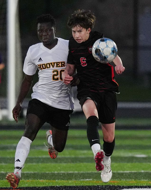 Des Moines Hoover forward Stephano Terekeza (20) races Ames' Gavin Murphy (6) to the ball during the first half of the Class 3A No. 3 Huskies' boys soccer game against Ames on May 1 at the Ames High Football Stadium in Ames, Iowa.