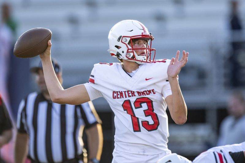 Center Grove High School freshman Oscar Sloan (13) warms up on the field before the start of an IHSAA varsity football game against Indianapolis Cathedral High School, Friday, Oct. 4, 2024, at Marian University.