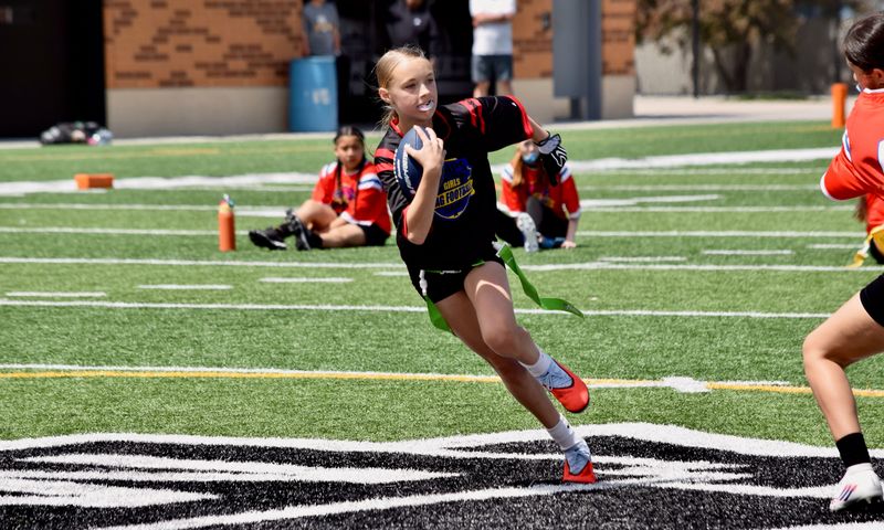 Hoyt Middle School's Kaylee Branchcomb runs with the ball during a girls flag football game at Mediacom Stadium on Sunday, May 3, 2026.