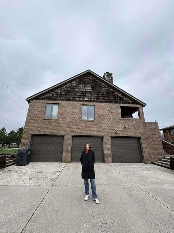 Anchored Hope Executive Director Wendy Van Dyke stands in front of the non-profit's home for former foster care youth.