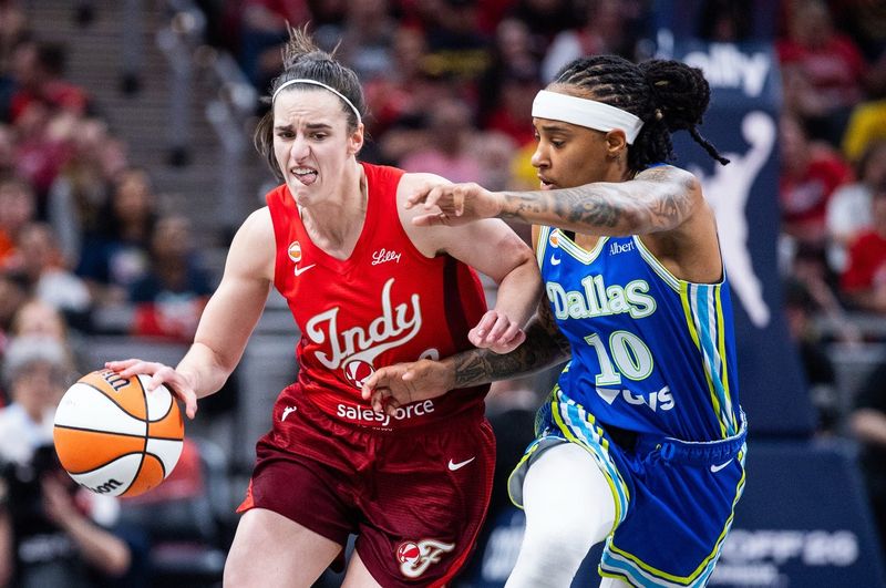 May 9, 2026; Indianapolis, Indiana, USA; Indiana Fever guard Caitlin Clark (22) dribbles the ball while Dallas Wings guard Aziaha James (10) defends in the first half at Gainbridge Fieldhouse. Mandatory Credit: Trevor Ruszkowski-Imagn Images