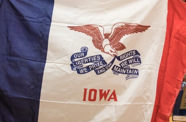 The Iowa state flag is seen in 2017