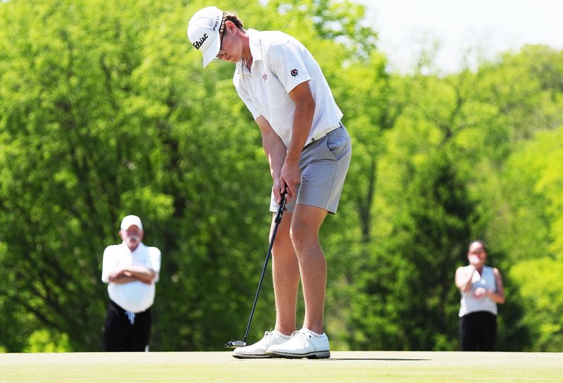 Gilbert’s Johnathan Bouska putts the ball onto the 18th hole during the Raccoon River Conference boys golf meet at the Veenker Memorial Golf Course in Ames, Iowa. Bouska is hoping to qualify for state in Class 3A again and make a run at an individual state championship.