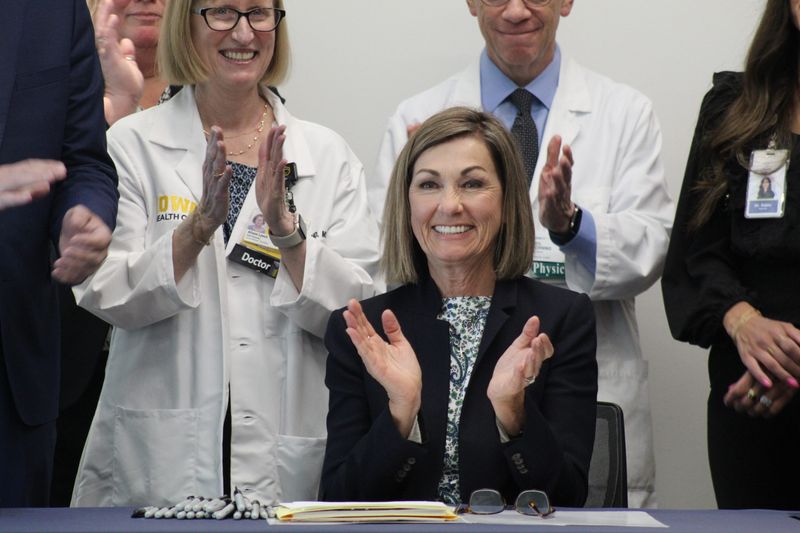 Iowa Gov. Kim Reynolds approves legislation aimed at reducing barriers on prior authorization requests and streamlining the process for healthcare workers during a bill signing at the Monroe County Hospital in Albia, May 13, 2026.